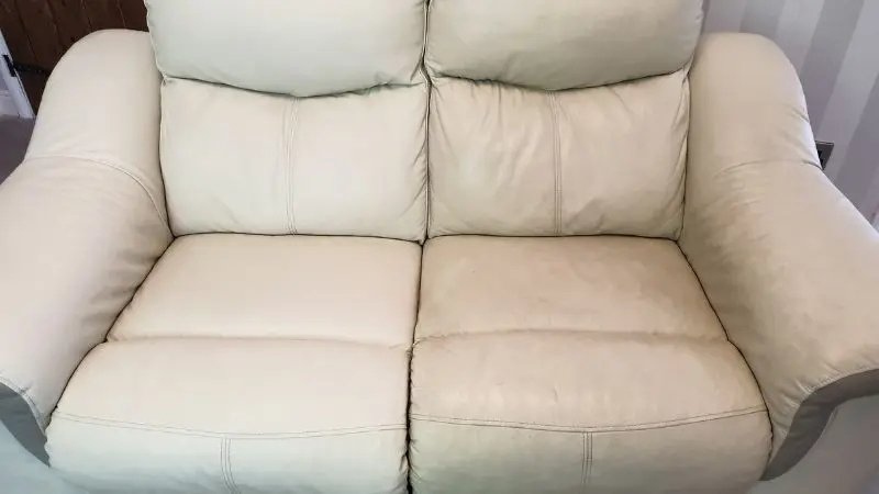 A photo of a 2 seater cream coloured leather sofa. The left side has been cleaned and looks brighter and beautifully clean. The right side looks worn and dirty. A noticeable difference between both sides.