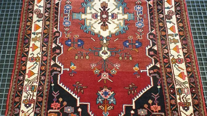 An oriental wool rug lad out following a deep clean.
